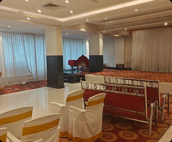 The hall draped in white with the stage set for a function
